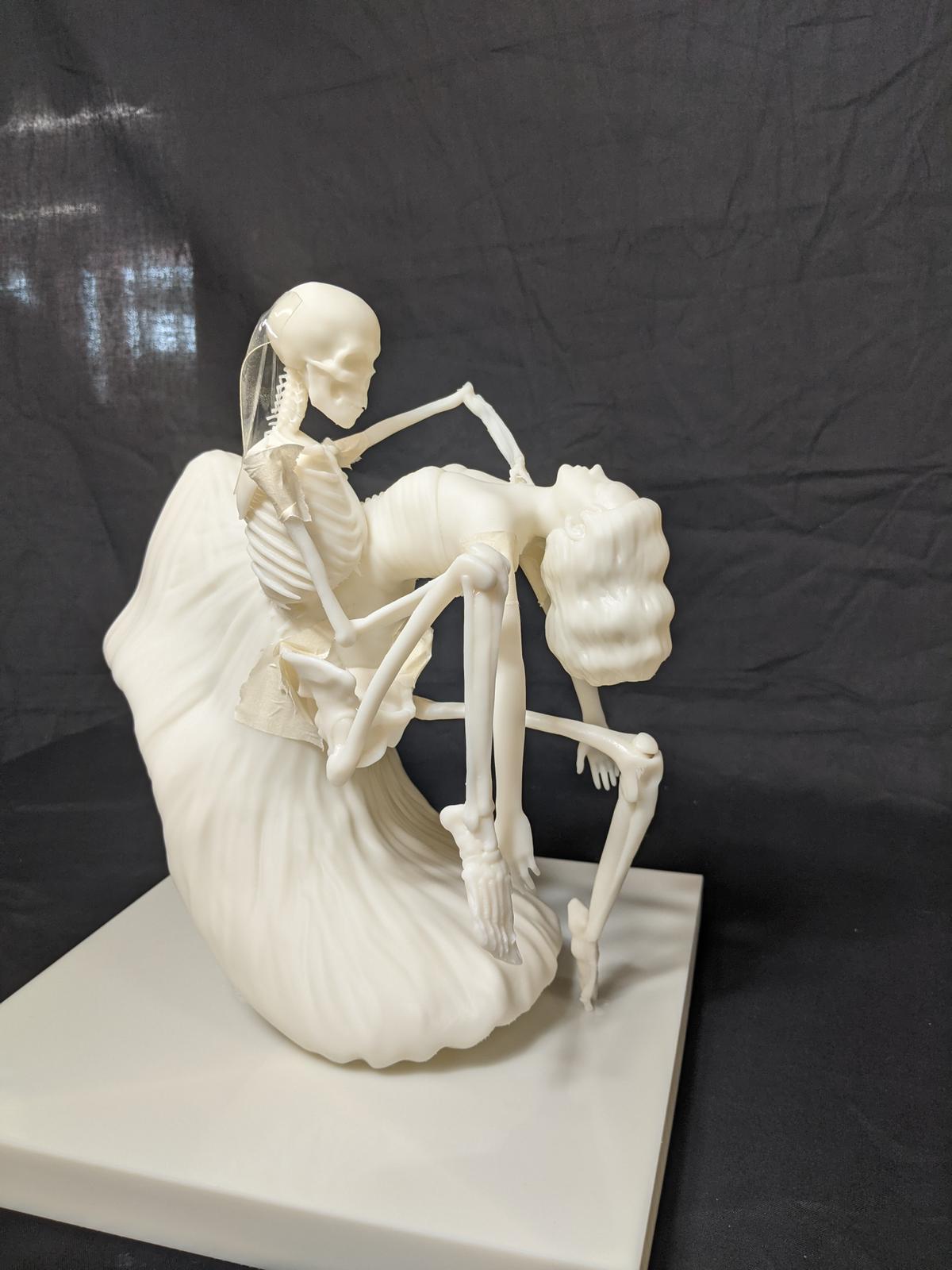 Dry-assembled proof — figure and skeleton in their final pose.