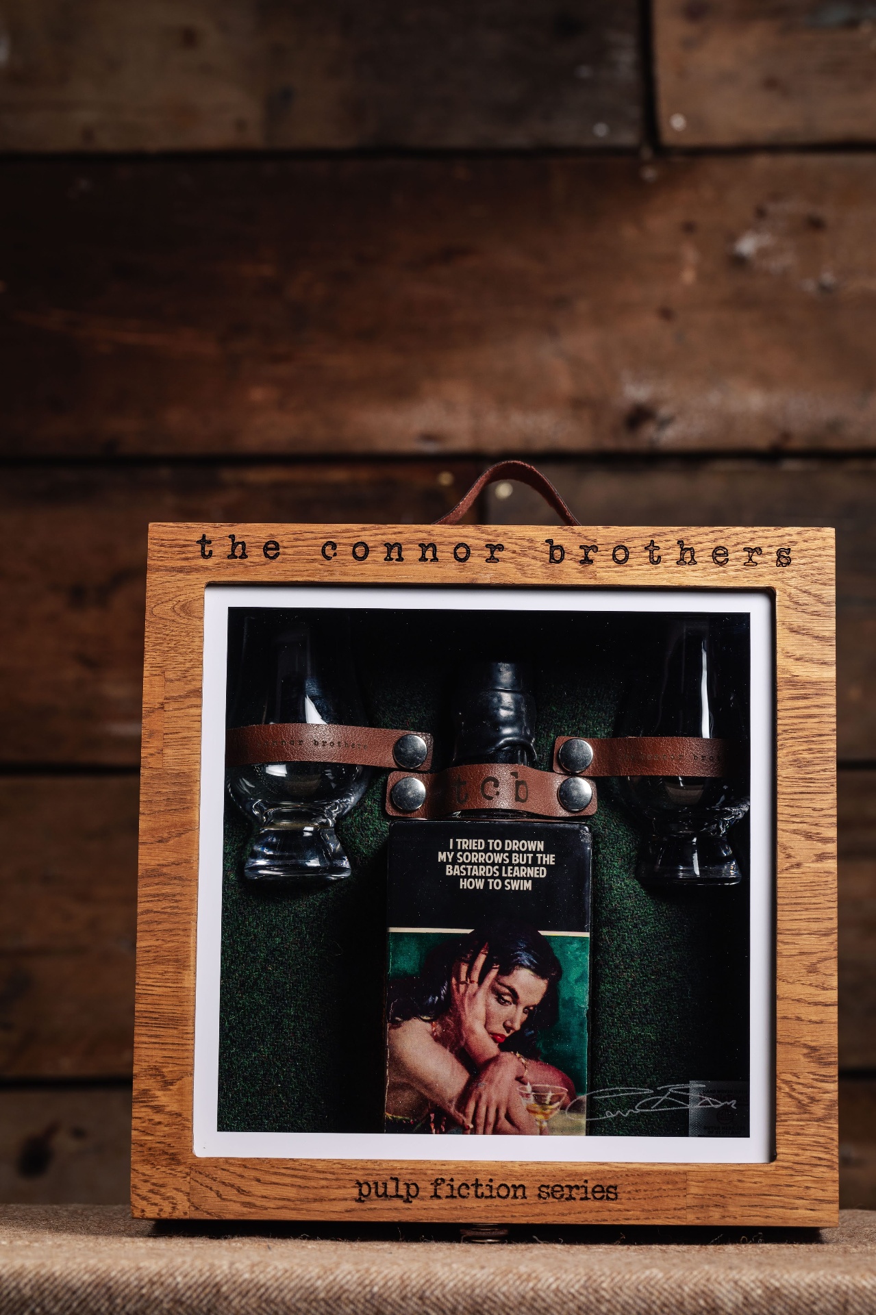 Engraved lid — "the connor brothers / pulp fiction series" laser-cut into solid white oak.