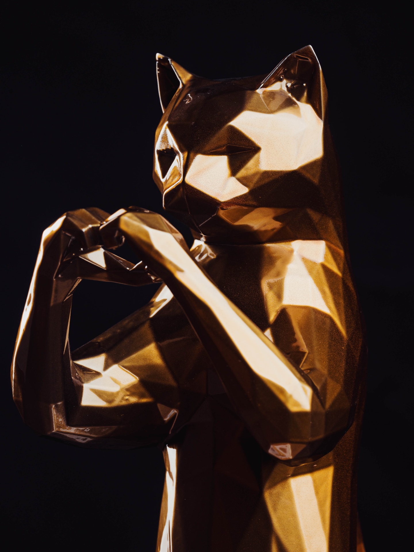 Three-quarter view, gold leaf catching the studio light