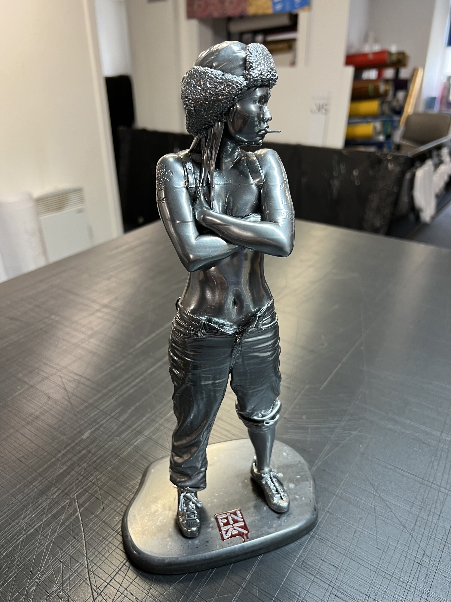 Dark chrome finish — full figure on the rounded Corian plinth, 3D logo UV printed direct to the base.