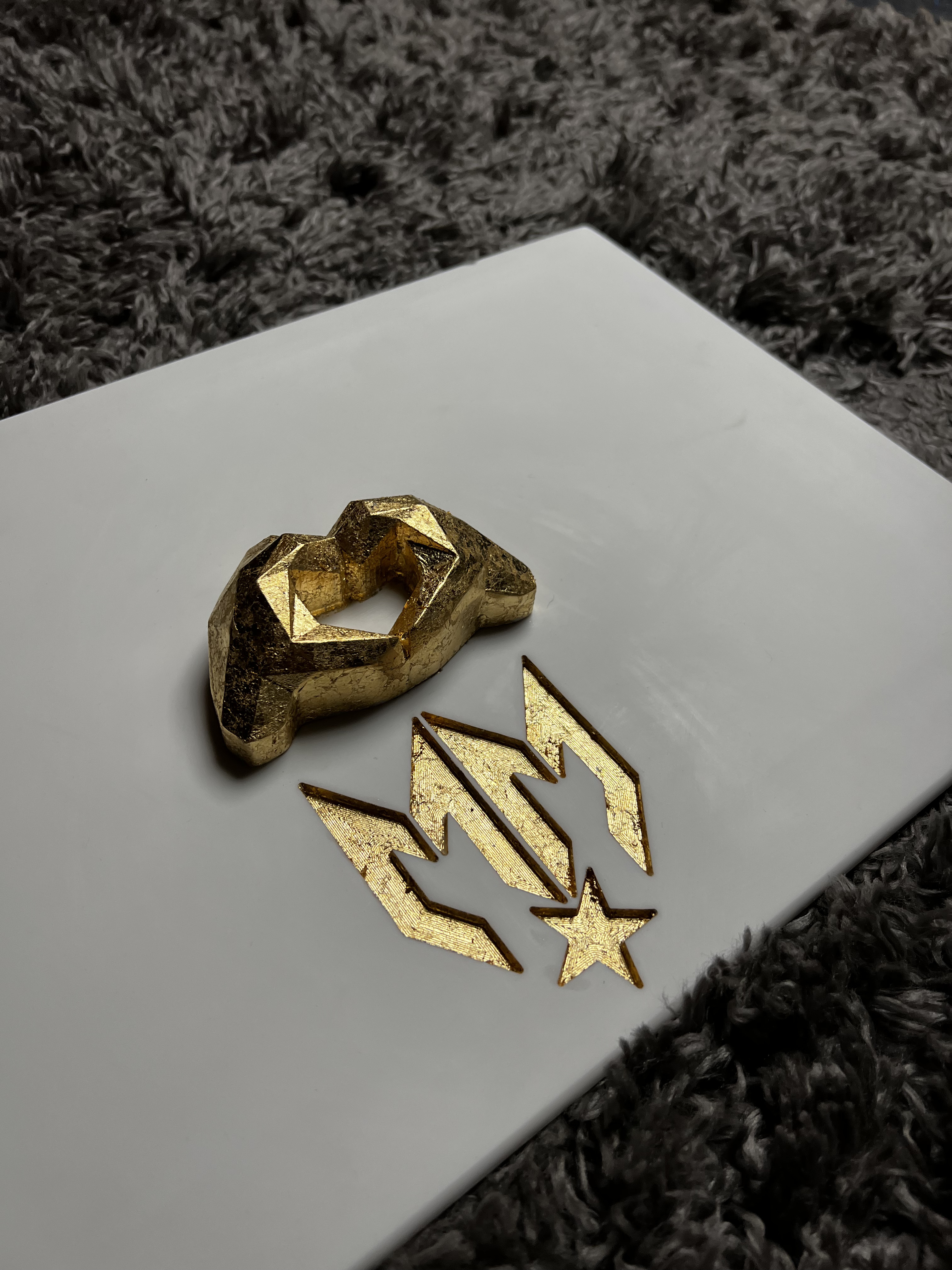 Gold-leafed components and 3D-printed Maxim mark, ready for assembly