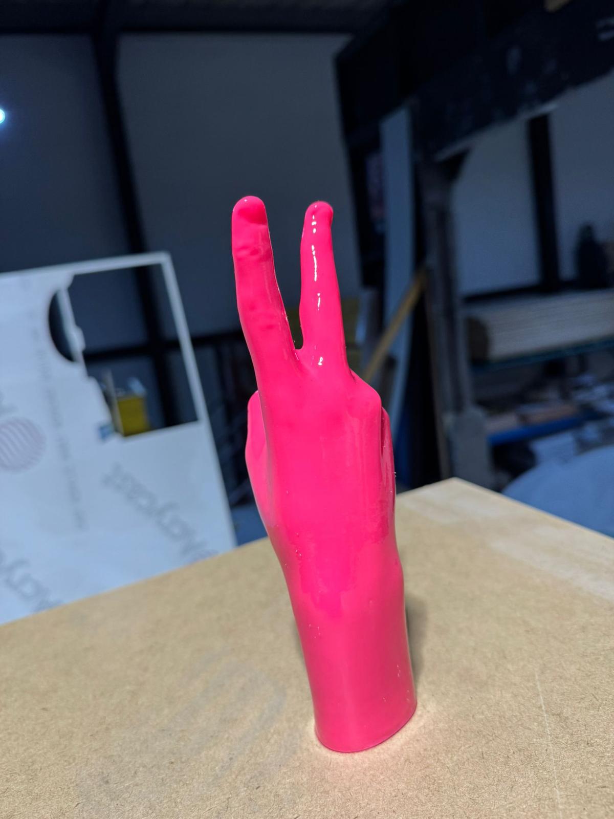 Front-on — fingers reading clean as a peace sign, gloss catching the studio light.