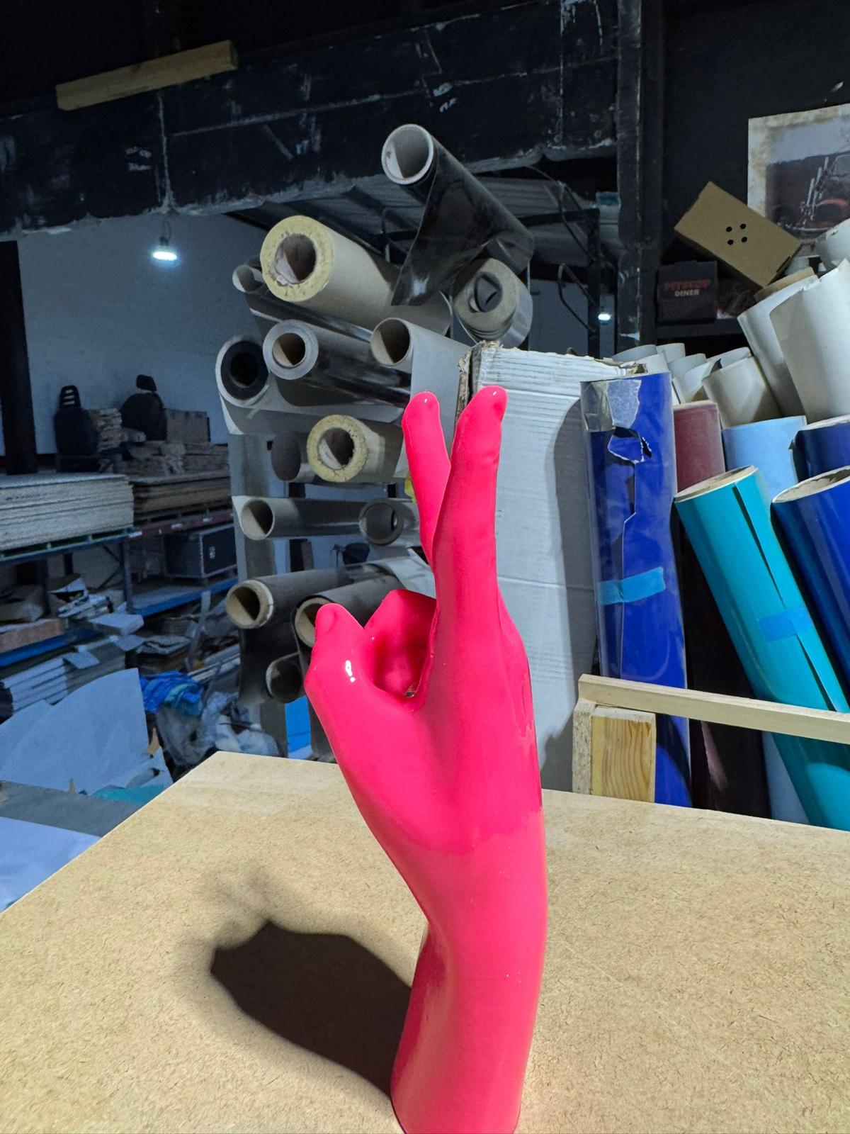 Studio shot — gloss neon pink standing out against the workshop backdrop.